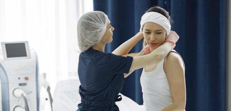 Nurse placing a dressing on woman's head